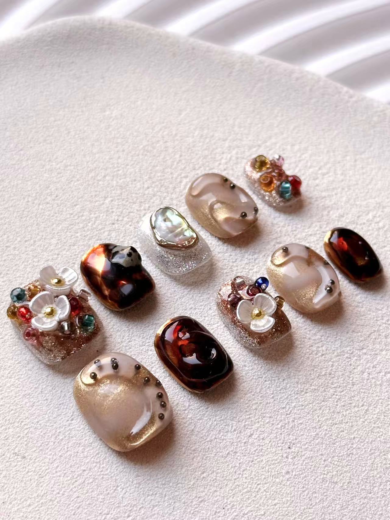 Full 10-piece set of luxury press-on nails featuring  3D white floral designs