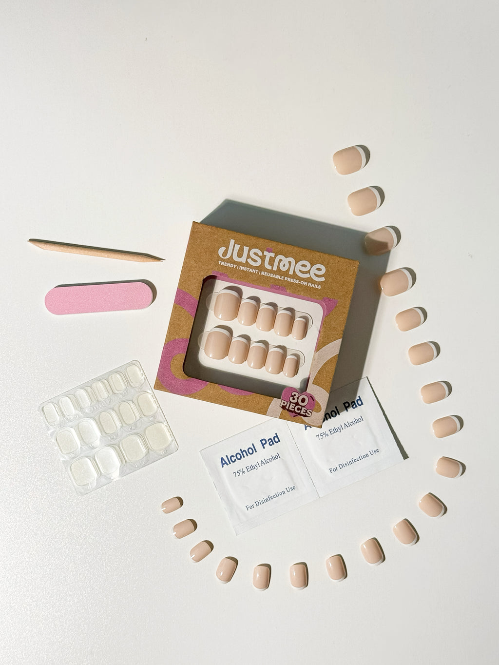 Justmee at-home manicure kit featuring 30 micro French press-on nails and application tools.