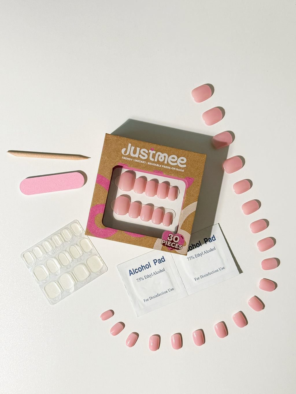 Justmee 30-piece press-on nail kit featuring sheer aurora pink jelly nails and application tools.