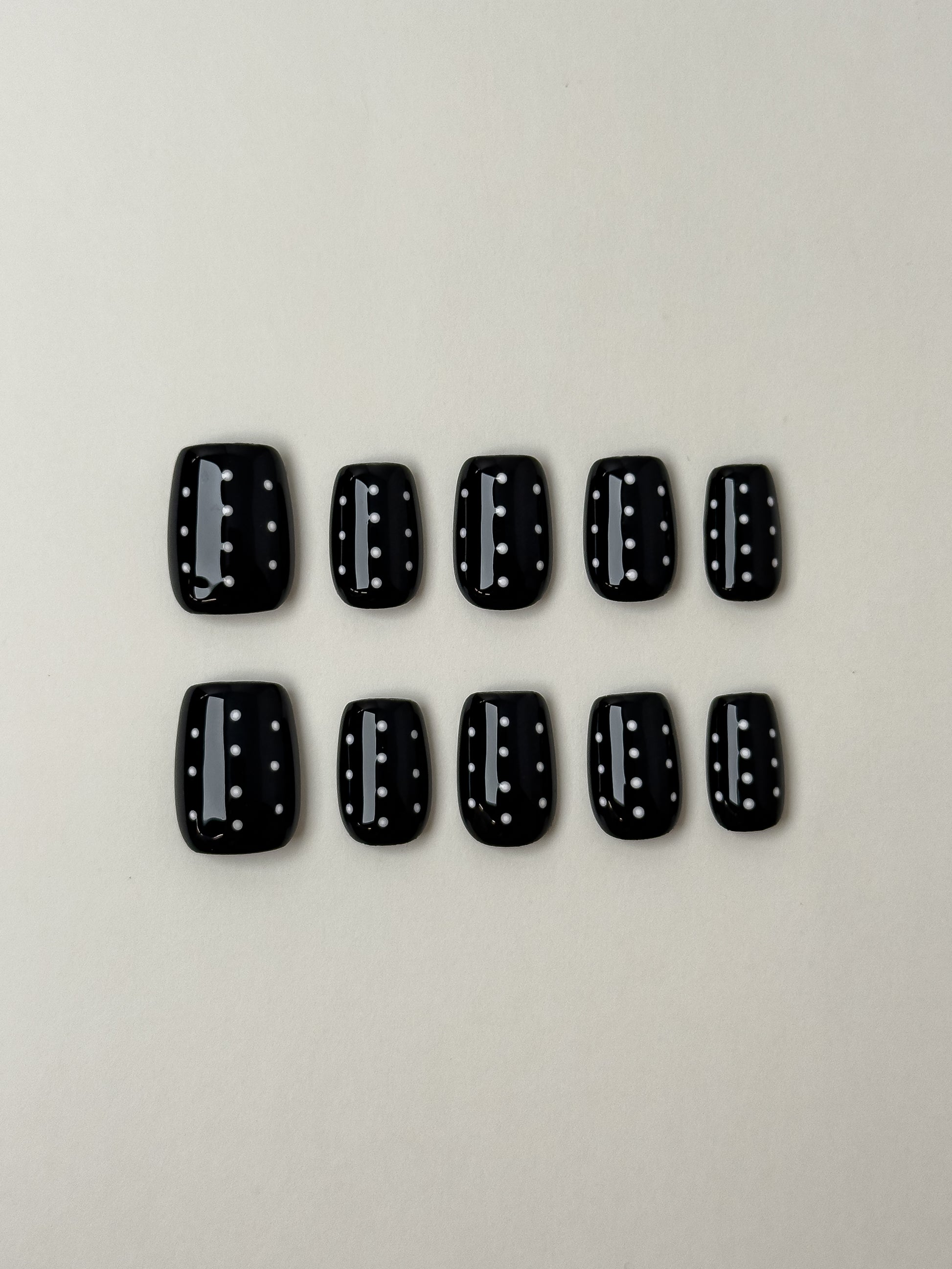Glossy black medium square press-on nails with white polka dot pattern from Justmee