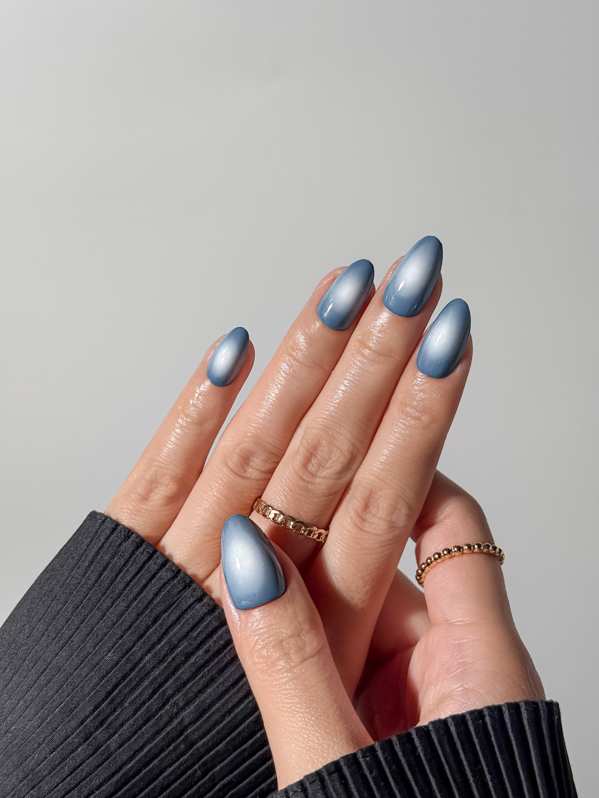 Close-up of blue magnetic gel press-on nails showing the multidimensional velvet shine.