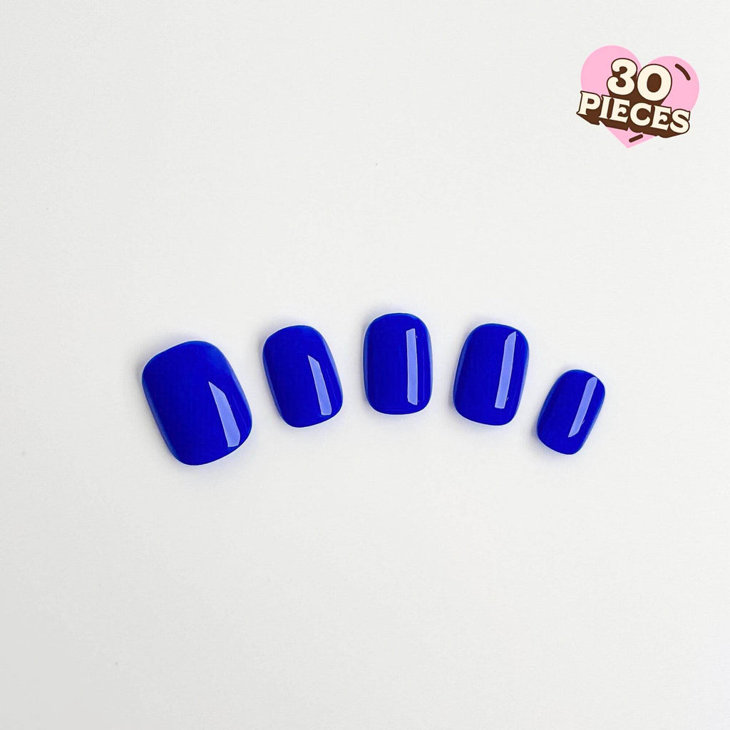 Vibrant cobalt blue press-on nails in a short square shape