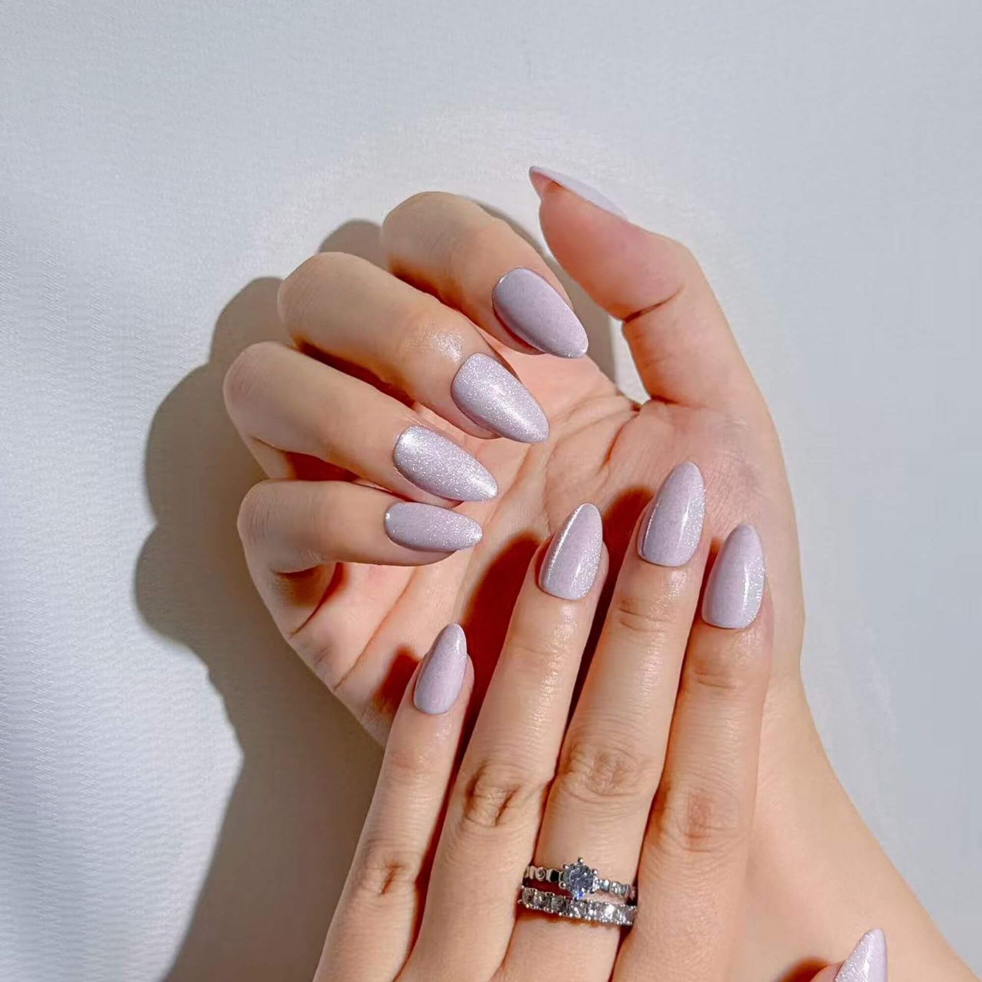 Manicure look with Justmee Lavendust shimmer lilac stick-on nails, short almond shape for a clean and professional style.