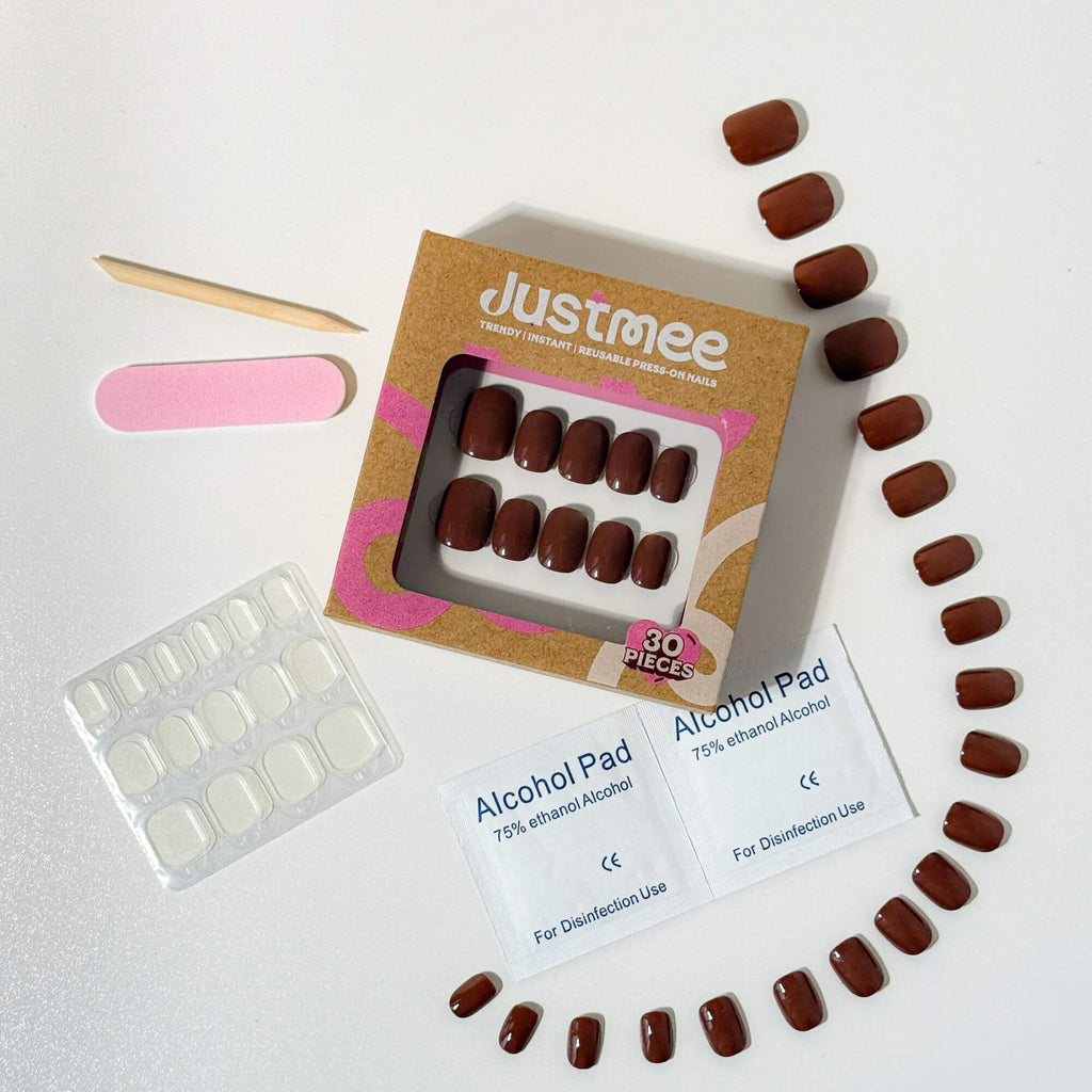 Justmee Mocha Glaze press-on nail kit featuring 30 pieces of espresso short artificial nails with application tools.
