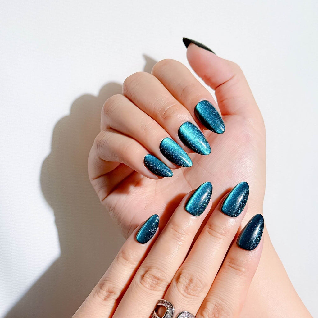 Professional manicure look with Justmee teal cat-eye stick-on nails, high-gloss shimmering finish on hands.