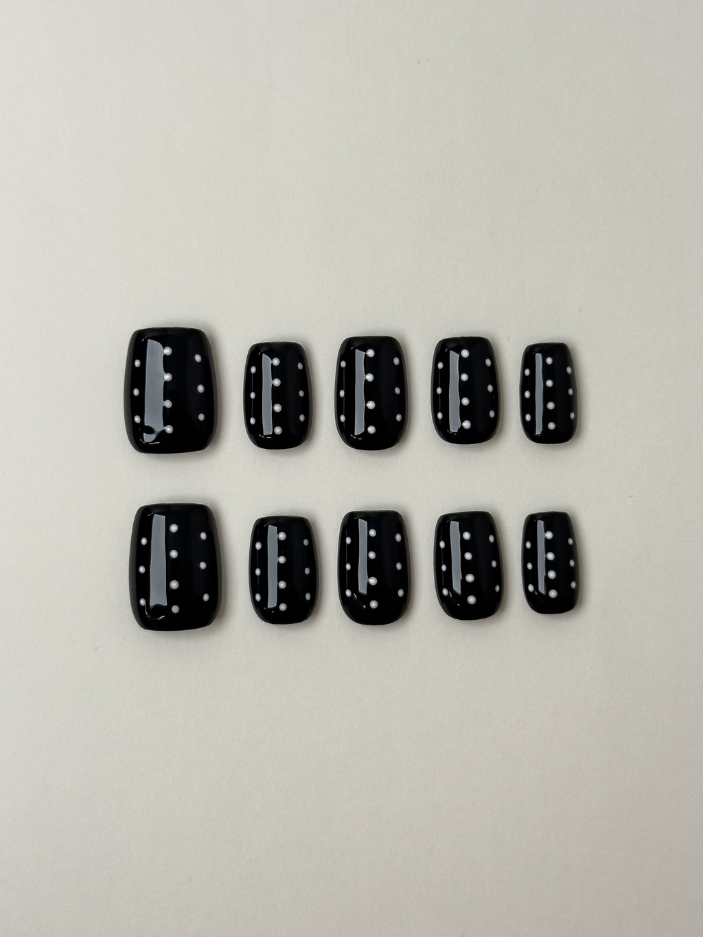 Glossy black short square press-on nails with white polka dot pattern from Justmee