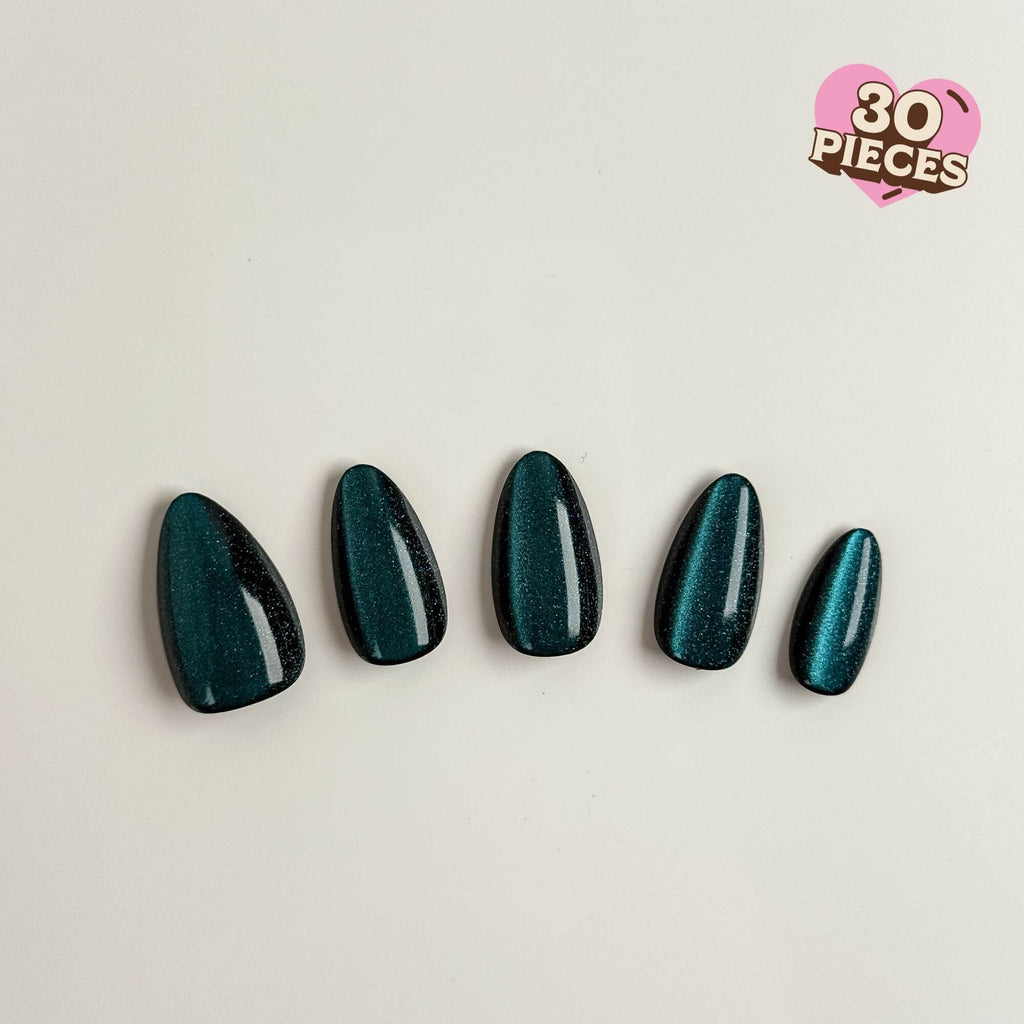 Detailansicht smaragdgrüner Cat-Eye Kunstnägel mit schimmerndem Galaxy-Effekt in eleganter Mandelform.