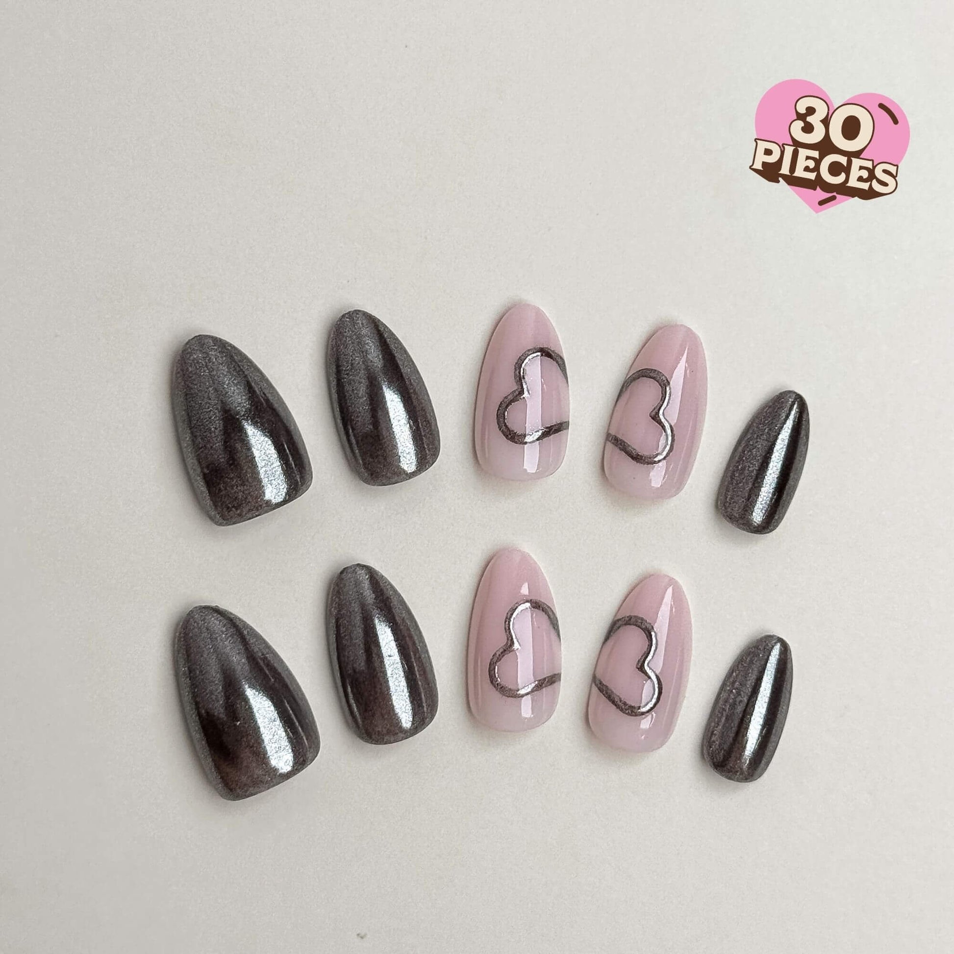 30-piece almond press-on nail set featuring gunmetal chrome and pink heart outline art. Medium almond shape and reusable.