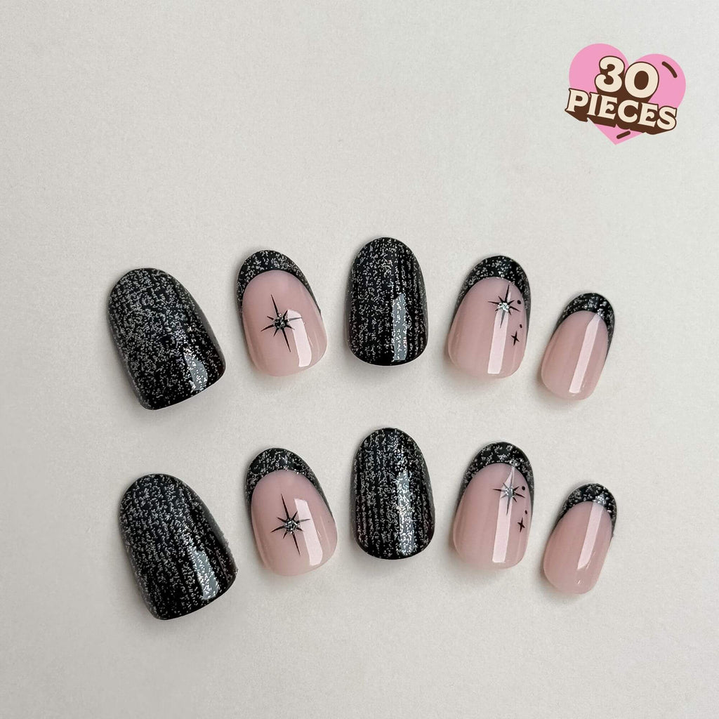 30-piece short round oval press-on nail set featuring black glitter French tips and starburst art.