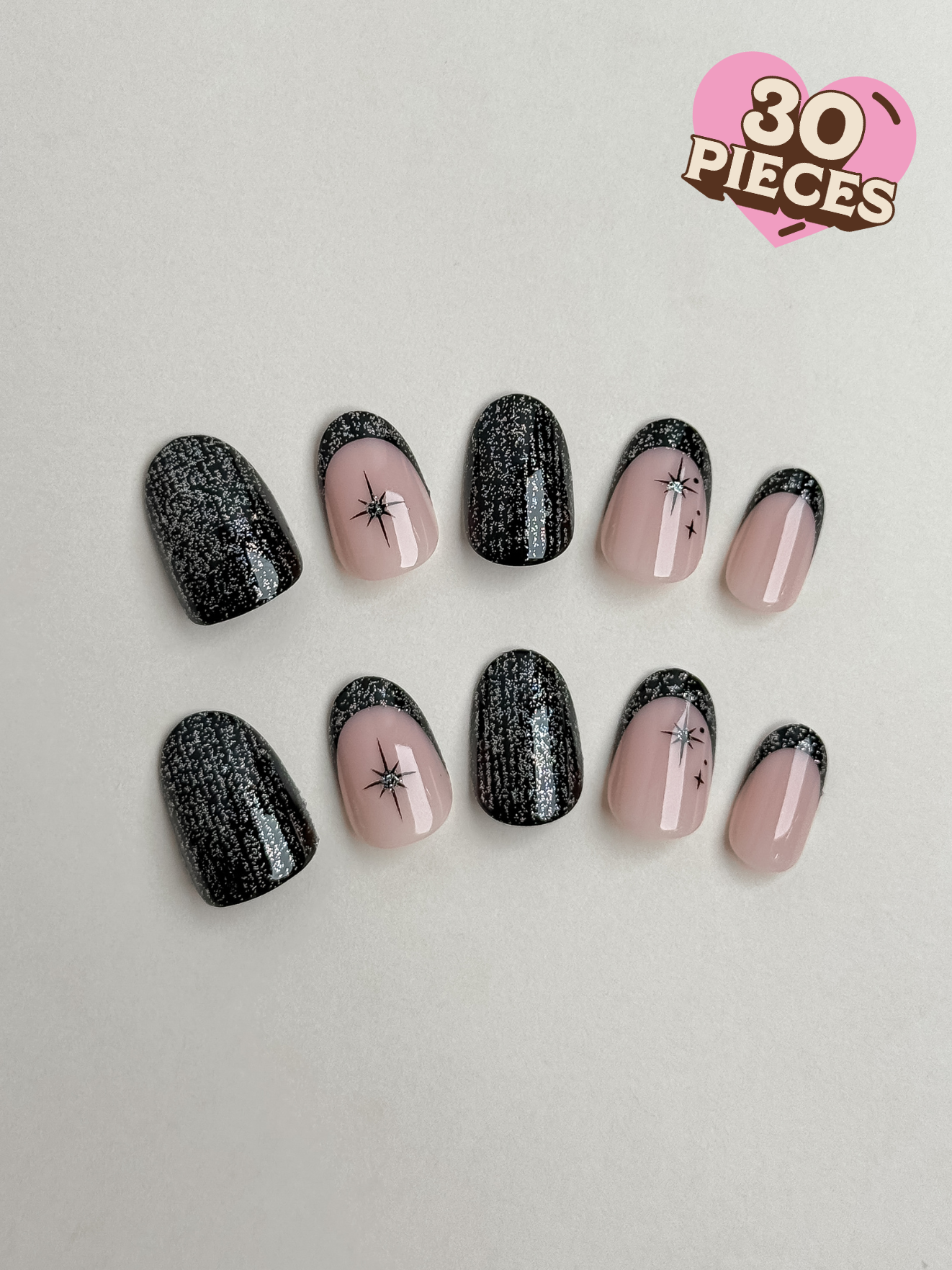 30-piece short round oval press-on nail set featuring black glitter French tips and starburst art.